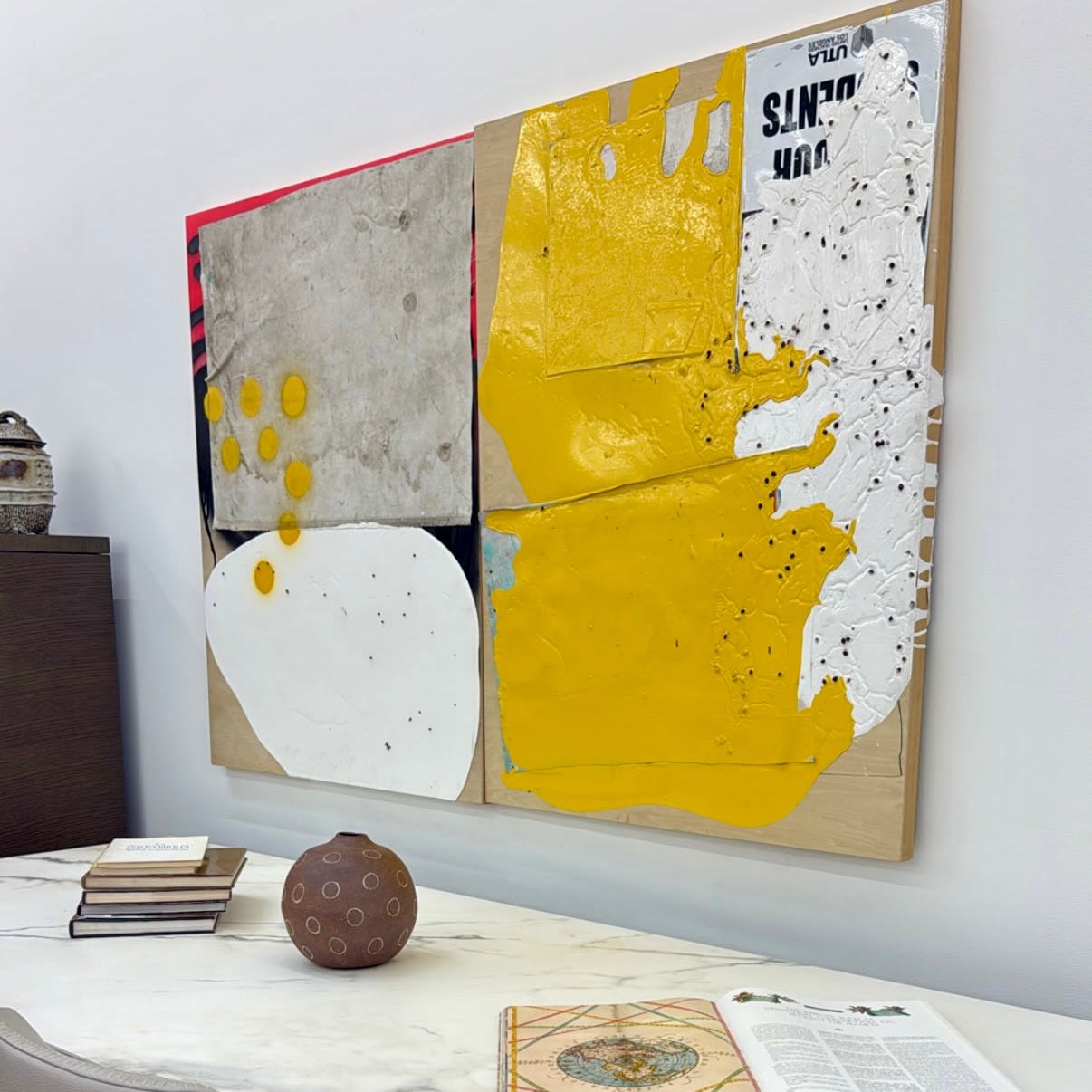 The diptych "Before We Met" by Allison Caesar displays a masterful mixed media technique: the left panel features intricately detailed gray, white, and yellow circles, while the right panel offers dynamic textures as yellow paint interacts with torn paper on a textured surface.
