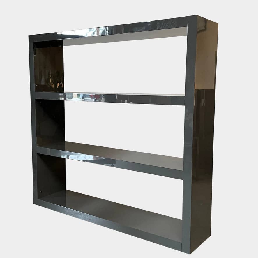 A black Minotti Johns Bookcase with three shelves on it.