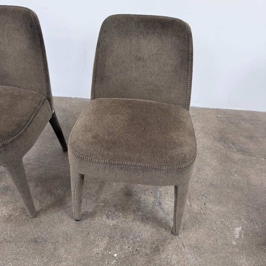Two dark gray Maxalto Febo dining chairs with backrests, leather upholstery, and four tapered legs.