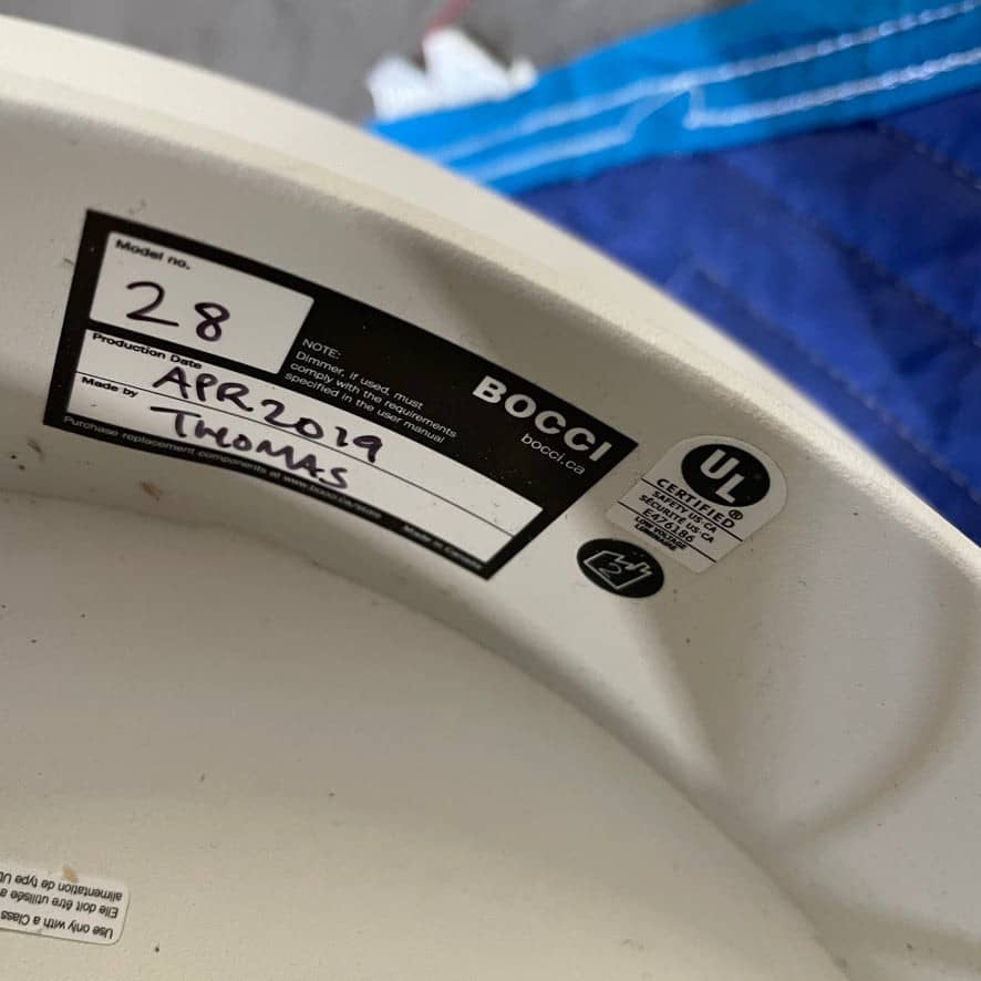 The Bocci Armature Chandelier T16.17aA1 by Bocci features multiple black branches with round, illuminated bulbs extending from a central base, offering a modern ceiling light fixture design inspired by contemporary aesthetics.