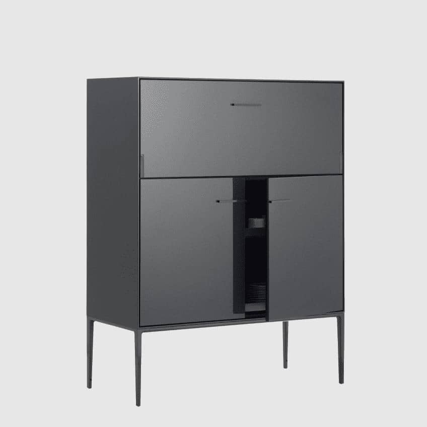 The B&B Italia Eucalipto Living Storage Unit is a sleek black metal cabinet with one drawer, two doors, and slim legs. It offers a minimalist and modern design, perfect for sophisticated bar storage.