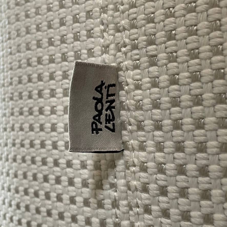 An adjustable white Paola Lenti Cove Double Sunbed by Paola Lenti features two separate reclining mattresses and matching pillows, perfect for outdoor lounging.