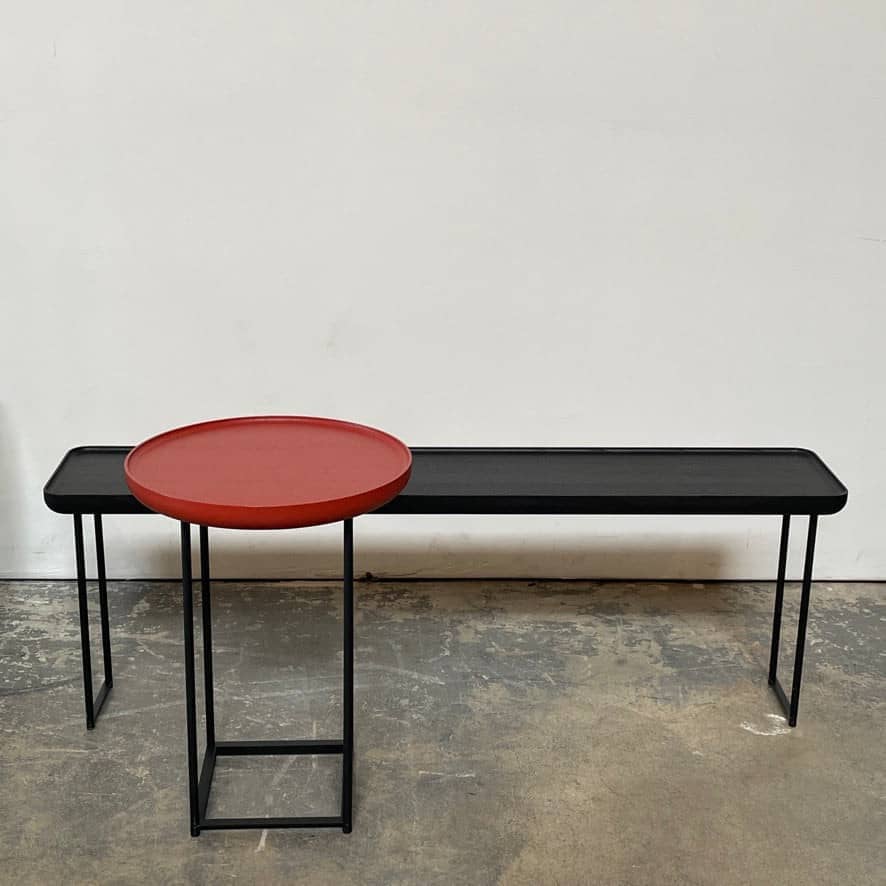 The Cassina Cassina Torei Side Table combines elegance and versatility with its red top and black base.