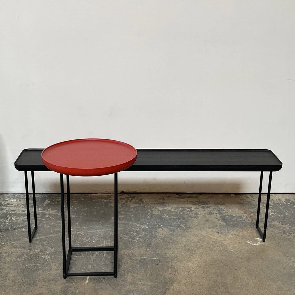 A sleek Cassina Torei Side Table with modern metal legs.