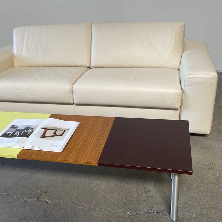 The Mazzei Multi-Panel Table by Mazzei is a contemporary design featuring a bench with a vibrant yellow, green, and blue top that adds functionality to any space.