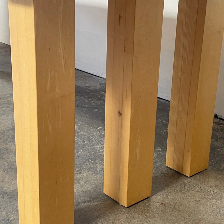 A Vintage Cassina La Basilica Dining Table by Mario Bellini, featuring a wooden rectangular design with a simple aesthetic and four legs, evocative of the iconic architectural style.