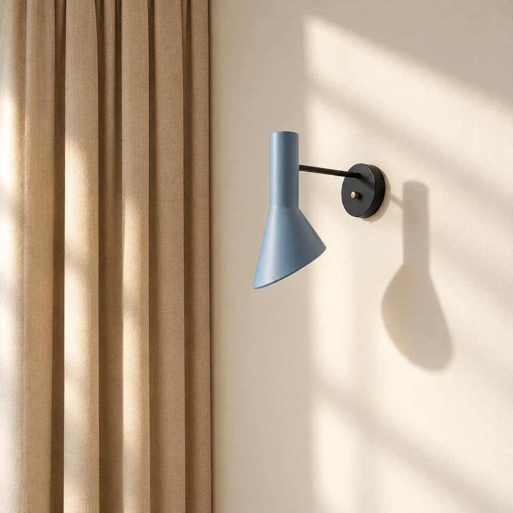 A gray Louis Poulsen AJ wall sconce with an adjustable conical shade.
