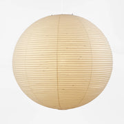 The Noguchi Akari 120A Suspension Lamp by Noguchi, a round beige paper lantern with horizontal ribbing, hangs against a plain white background, showcasing the timeless elegance of Japanese craftsmanship.