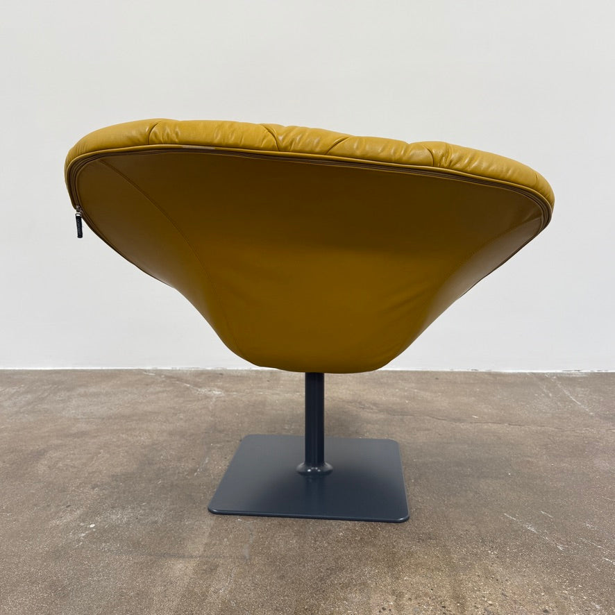 The Moroso Bohemian Low Armchair by Moroso features mustard yellow tufted leather upholstery, a matching cushion, and a black metal pedestal base, shown against a plain white background.