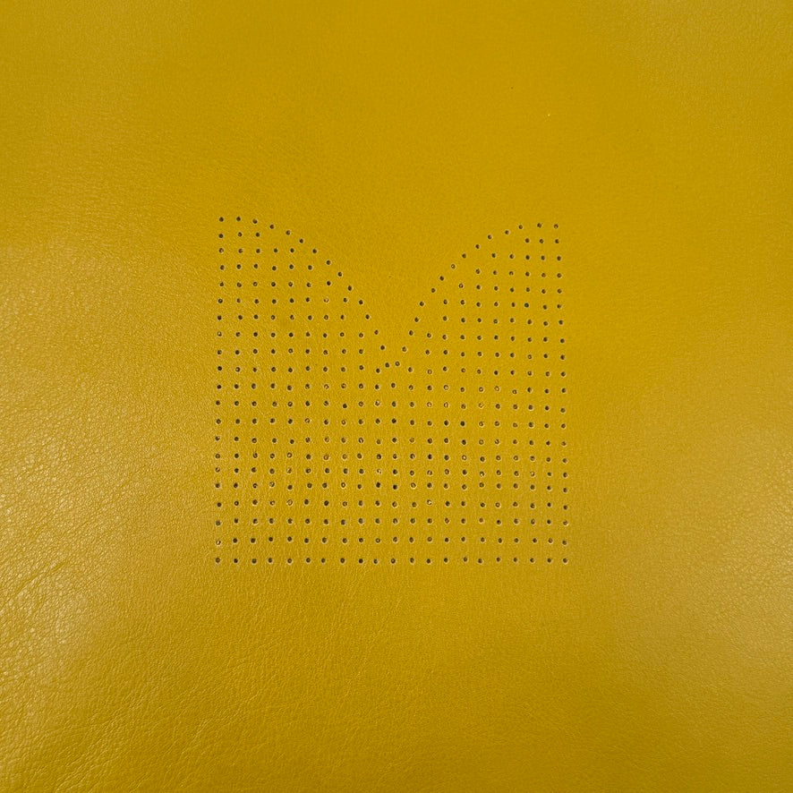 The Moroso Bohemian Low Armchair by Moroso features mustard yellow tufted leather upholstery, a matching cushion, and a black metal pedestal base, shown against a plain white background.