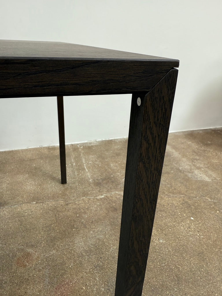 The Arco Slim Table by Arco is a minimalist rectangular table with a thin, flat surface and four slender legs, made from steel sandwich construction with a lightweight honeycomb core, shown against a plain white background.