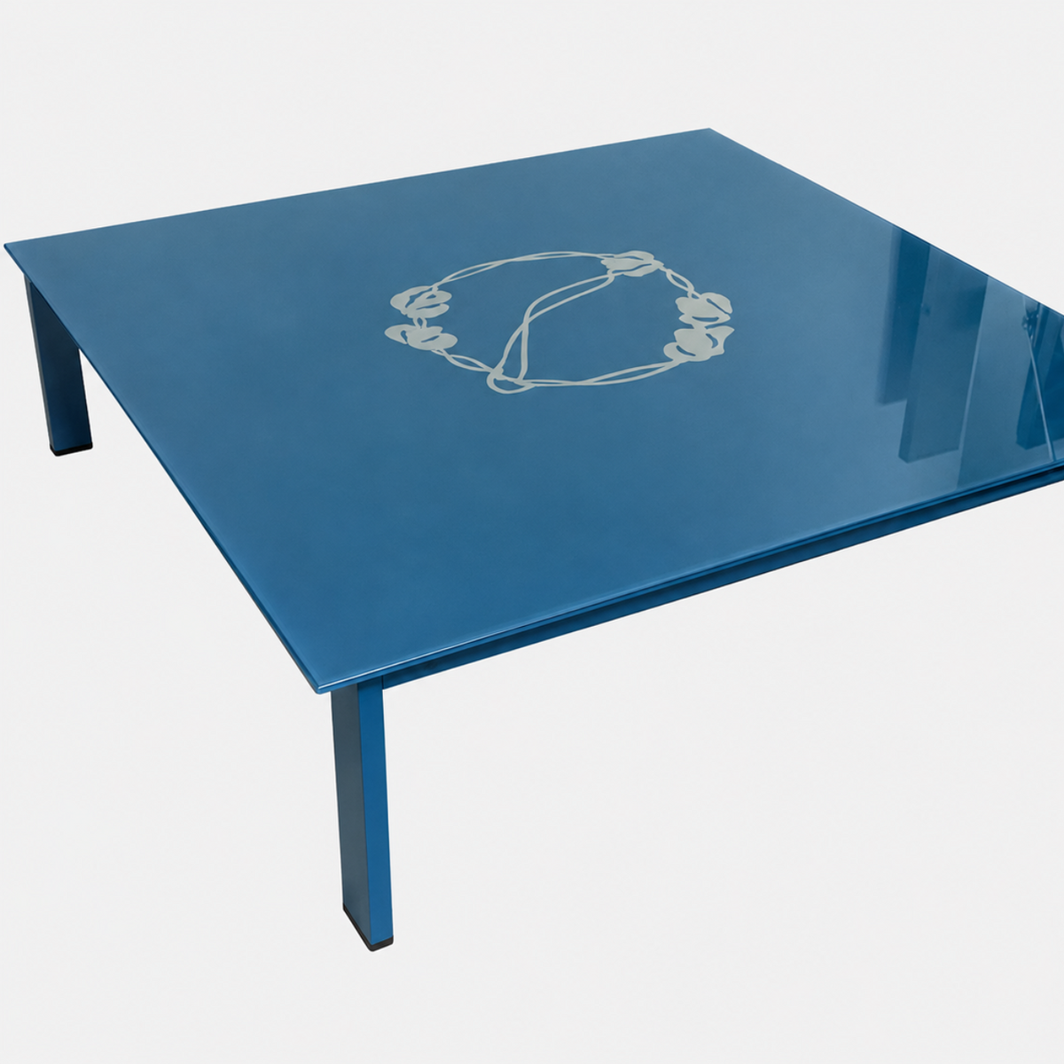 BD Barcelona Sevilla Coffee Table by BD Barcelona, a square coffee table in a reddish-brown hue with a glossy finish, features an intricate vine design at the center and a burgundy glass top. Photographed against a plain white background, this elegant piece combines sophisticated styling with fine craftsmanship.