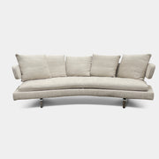 Experience the B&B Italia Arne Sofa, a modern off-white masterpiece with five plush cushions and cylindrical armrests. Designed by Antonio Citterio, it features sleek metal legs set against a crisp background.