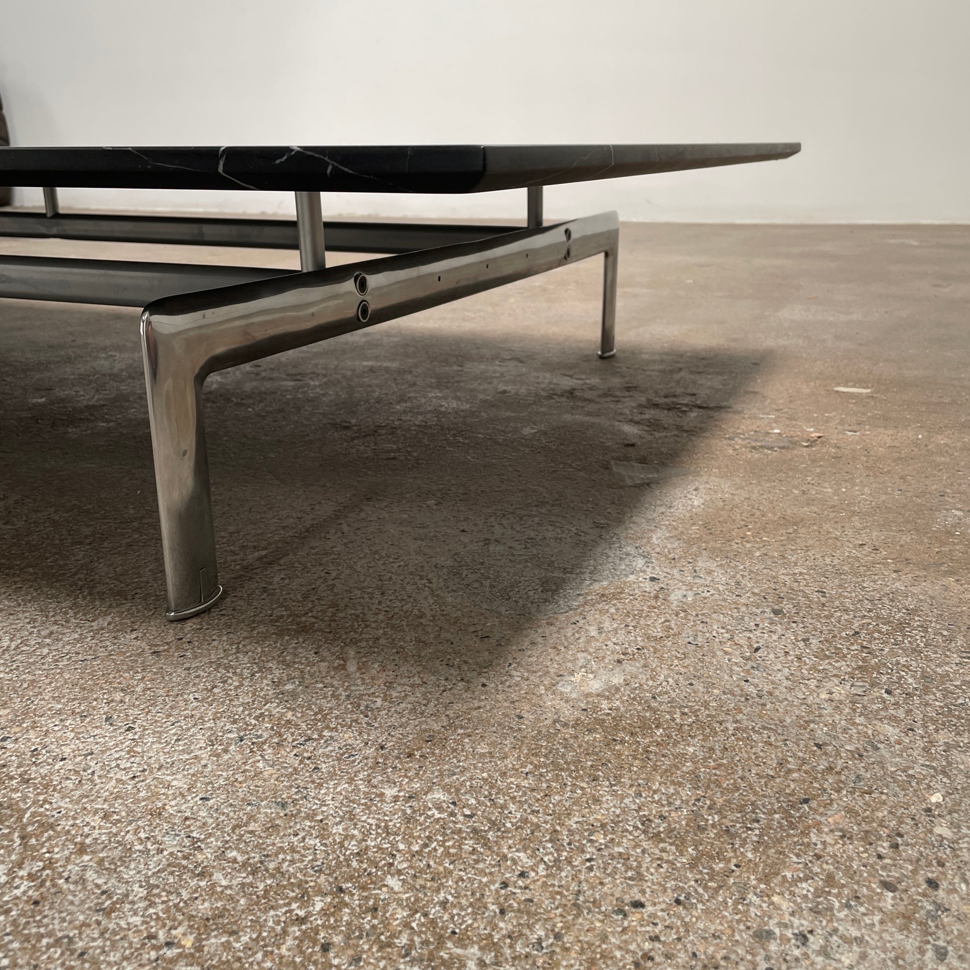 A minimalist rectangular black B&B Italia Diesis Coffee Table with metal legs, viewed directly from above, exudes timeless beauty against a plain white background.