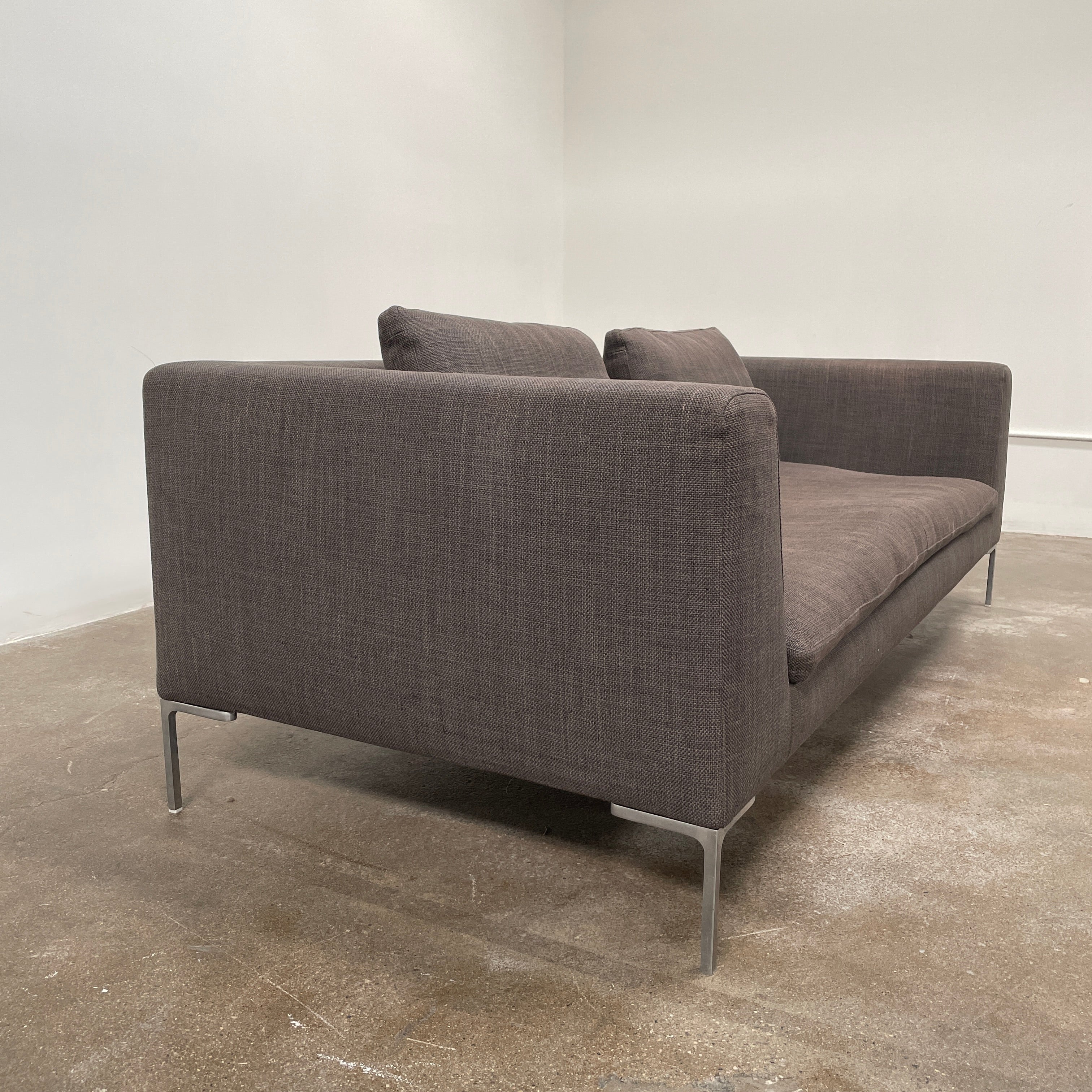 Elegant dark gray B&B Italia Charles Sofa with minimalist squared arms and two matching back cushions, showcased against a plain background.