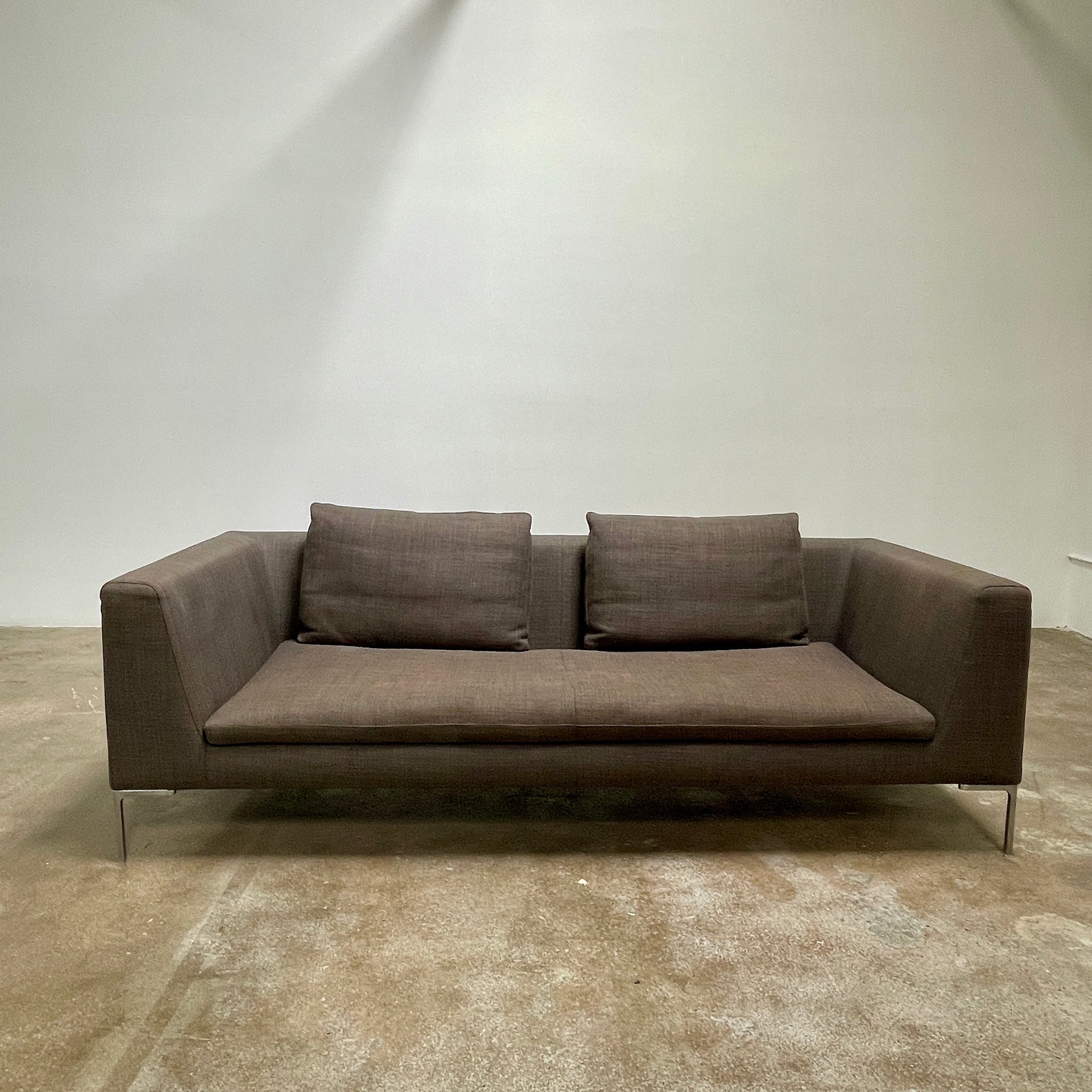 Elegant dark gray B&B Italia Charles Sofa with minimalist squared arms and two matching back cushions, showcased against a plain background.