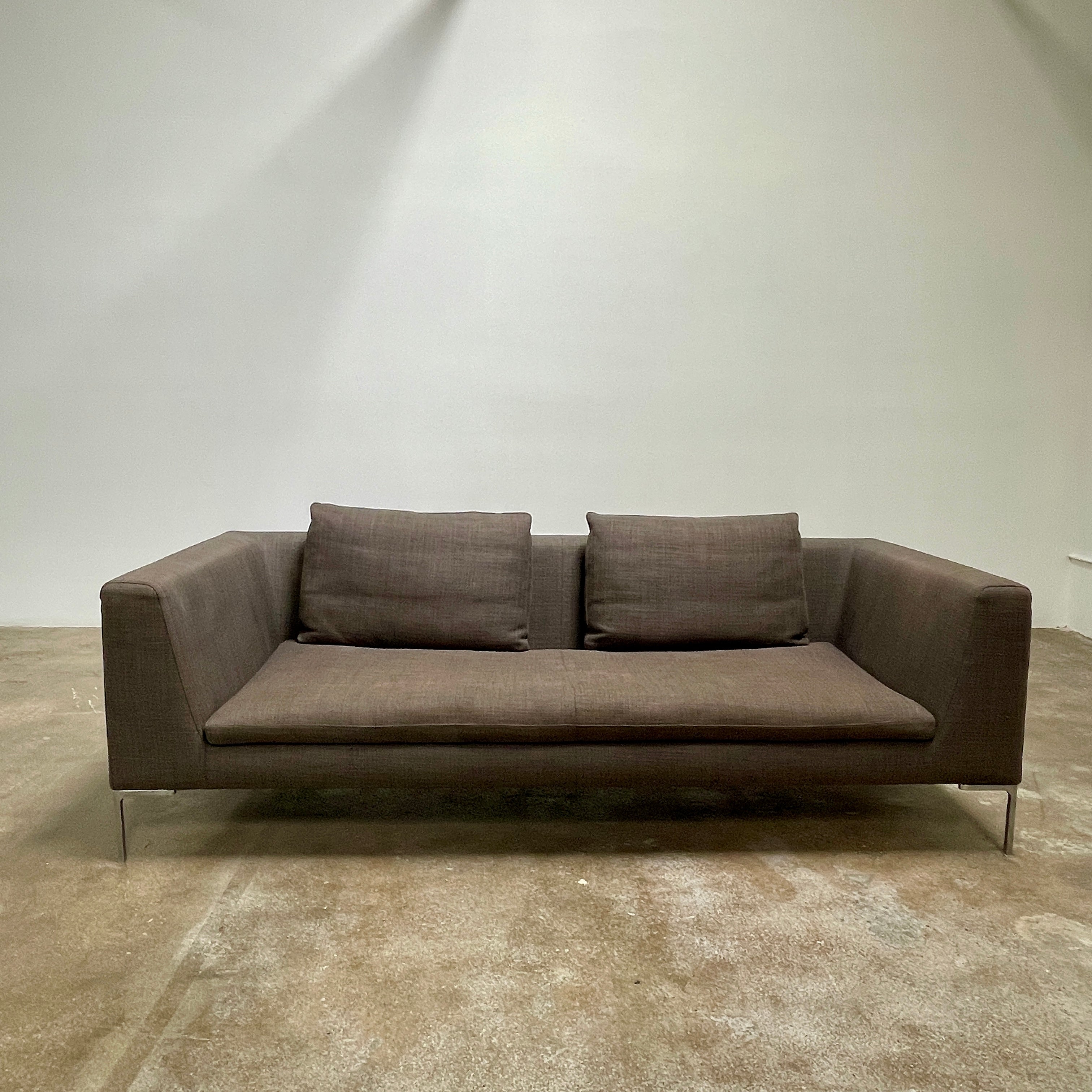 Elegant dark gray B&B Italia Charles Sofa with minimalist squared arms and two matching back cushions, showcased against a plain background.