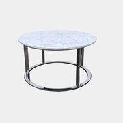 B&B Italia Mera Round Coffee Table with a white Carrara marble top and a dark metal circular base.