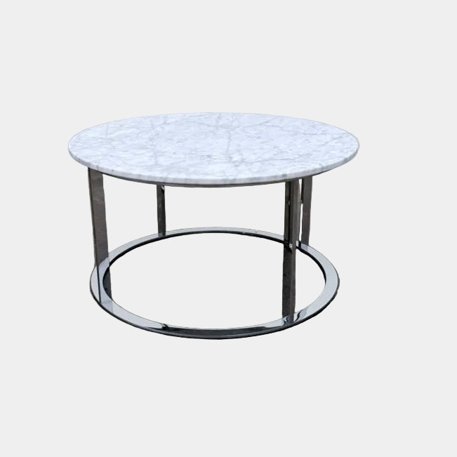 B&B Italia Mera Round Coffee Table with a white Carrara marble top and a dark metal circular base.