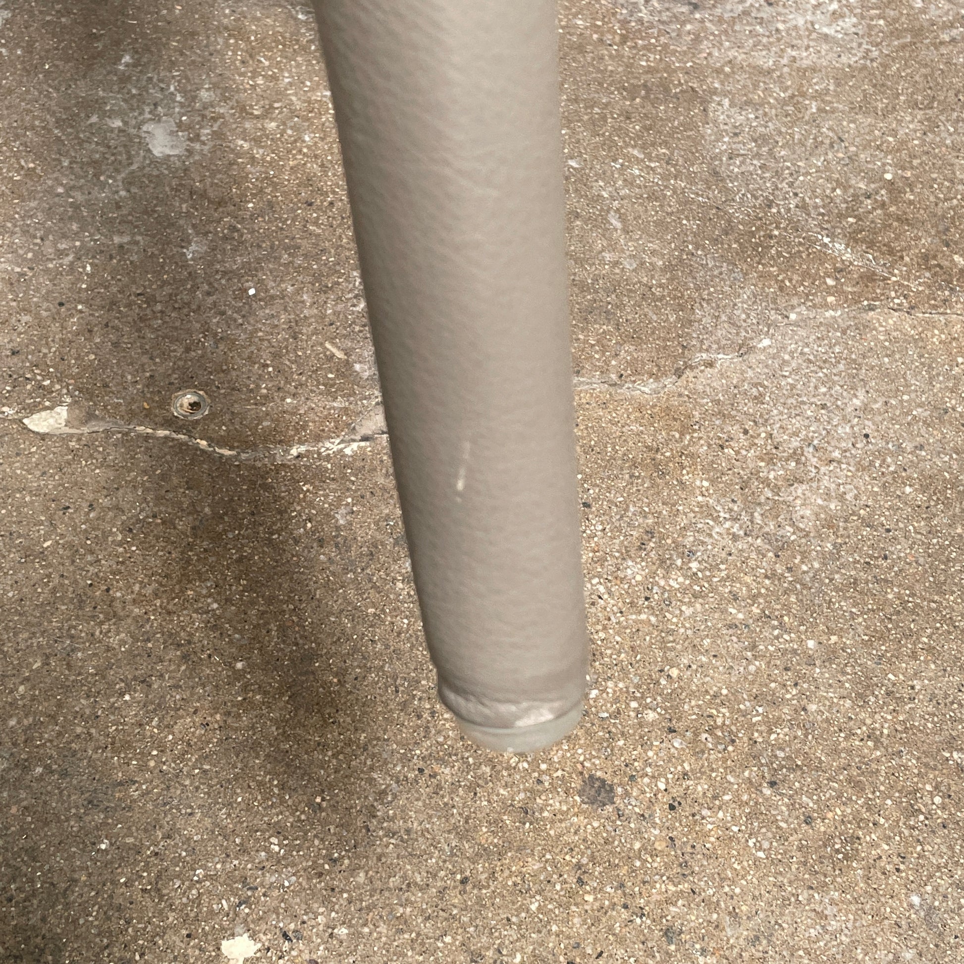 Six B&B Italia Vol au Vent Dining Chairs, embodying the elegance of Italian style, are arranged in two rows in an empty room with a concrete floor and a plain white wall.