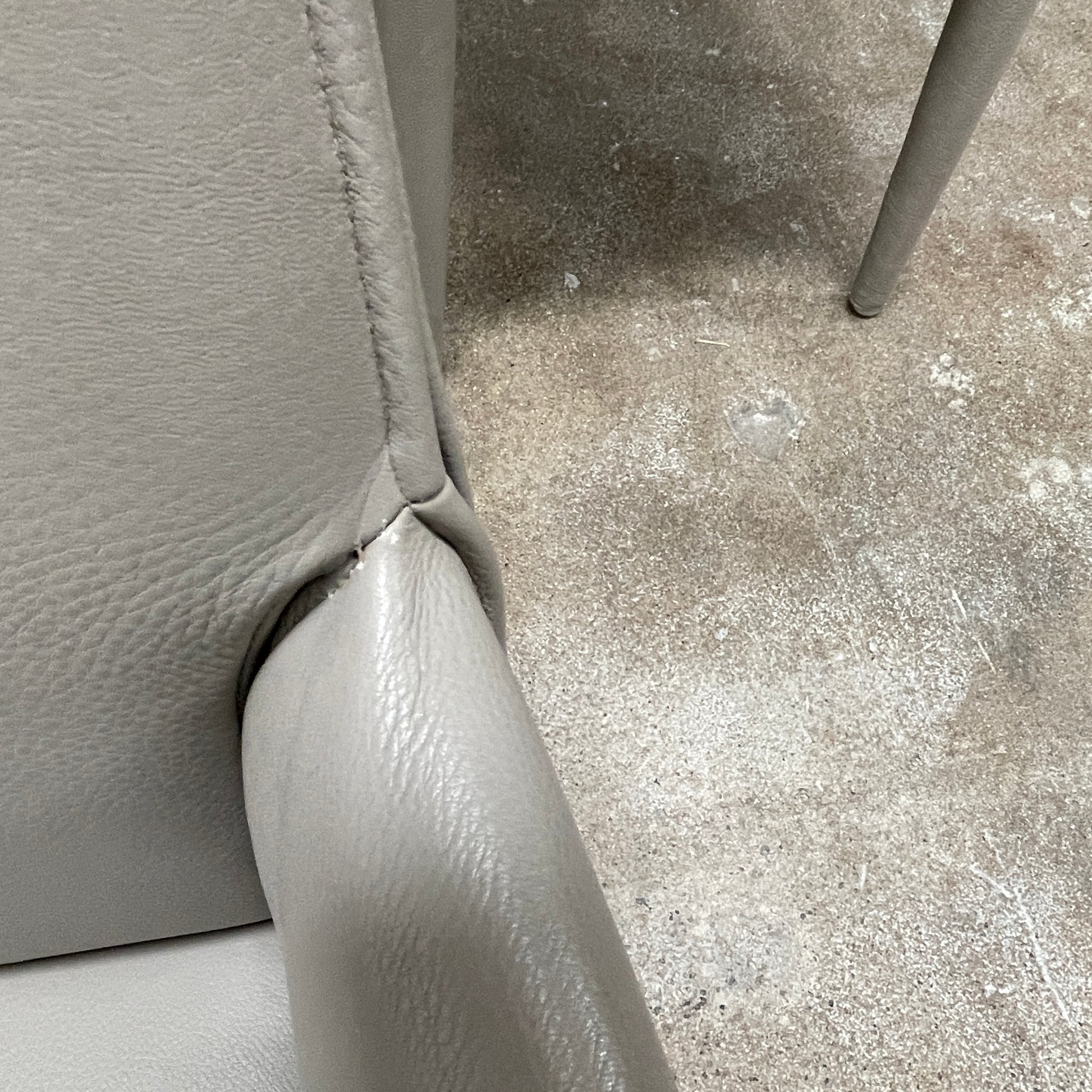 Six B&B Italia Vol au Vent Dining Chairs, embodying the elegance of Italian style, are arranged in two rows in an empty room with a concrete floor and a plain white wall.