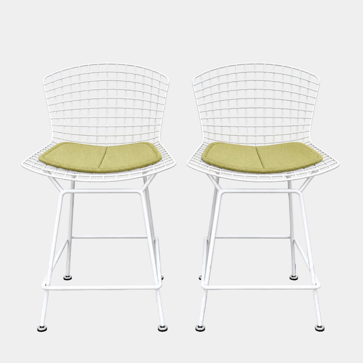 Two white Knoll Harry Bertoia Wire Counter Stools with light green seat cushions.