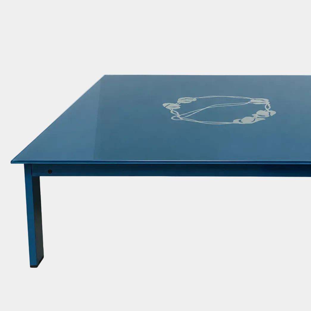 BD Barcelona Sevilla Coffee Table by BD Barcelona, a square coffee table in a reddish-brown hue with a glossy finish, features an intricate vine design at the center and a burgundy glass top. Photographed against a plain white background, this elegant piece combines sophisticated styling with fine craftsmanship.