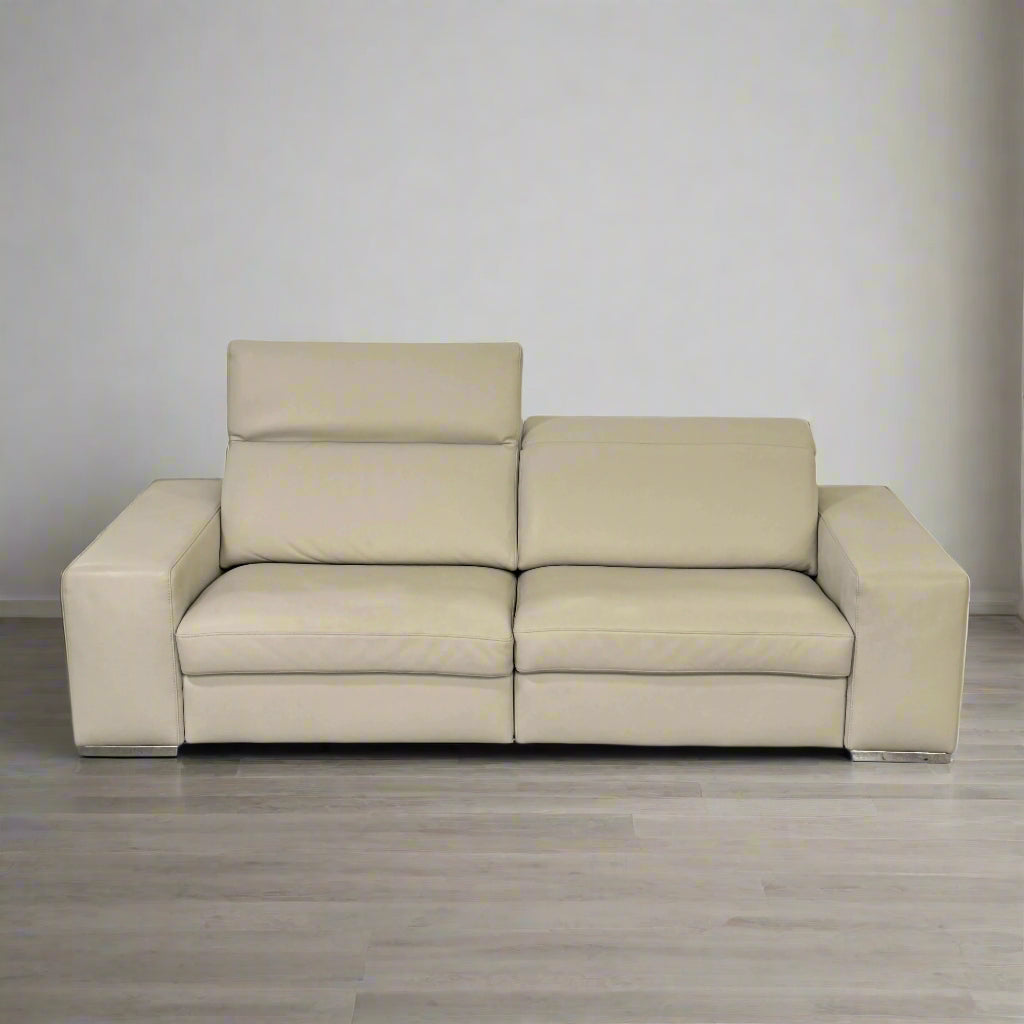 The Roche Bobois Leather Sofa With Movable Headrest features a modern beige design, wide armrests, metal legs, and an adjustable headrest—ideal for any contemporary living space.