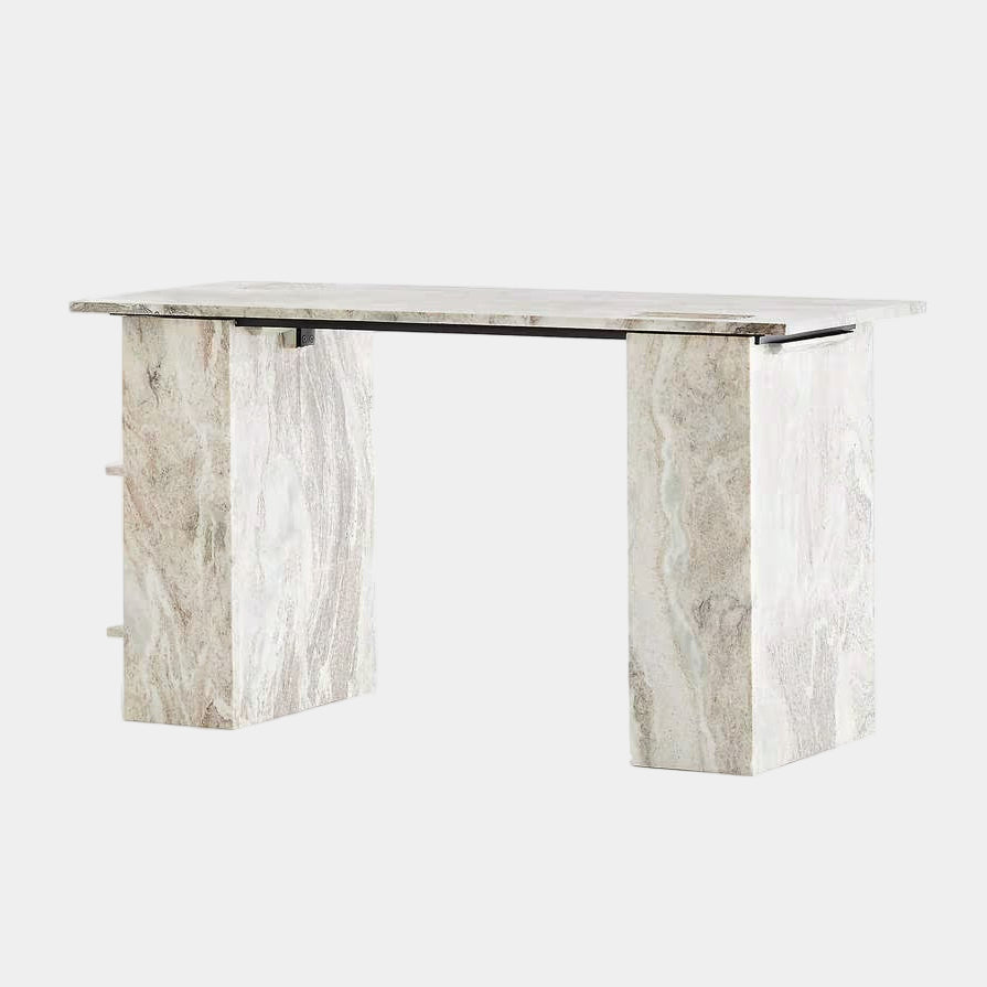 The CB2 Hera Torrento Brown Marble Desk with Shelves features two side panels and two open left corner shelves, showcasing a light gray and beige pattern inspired by Torrento brown marble.