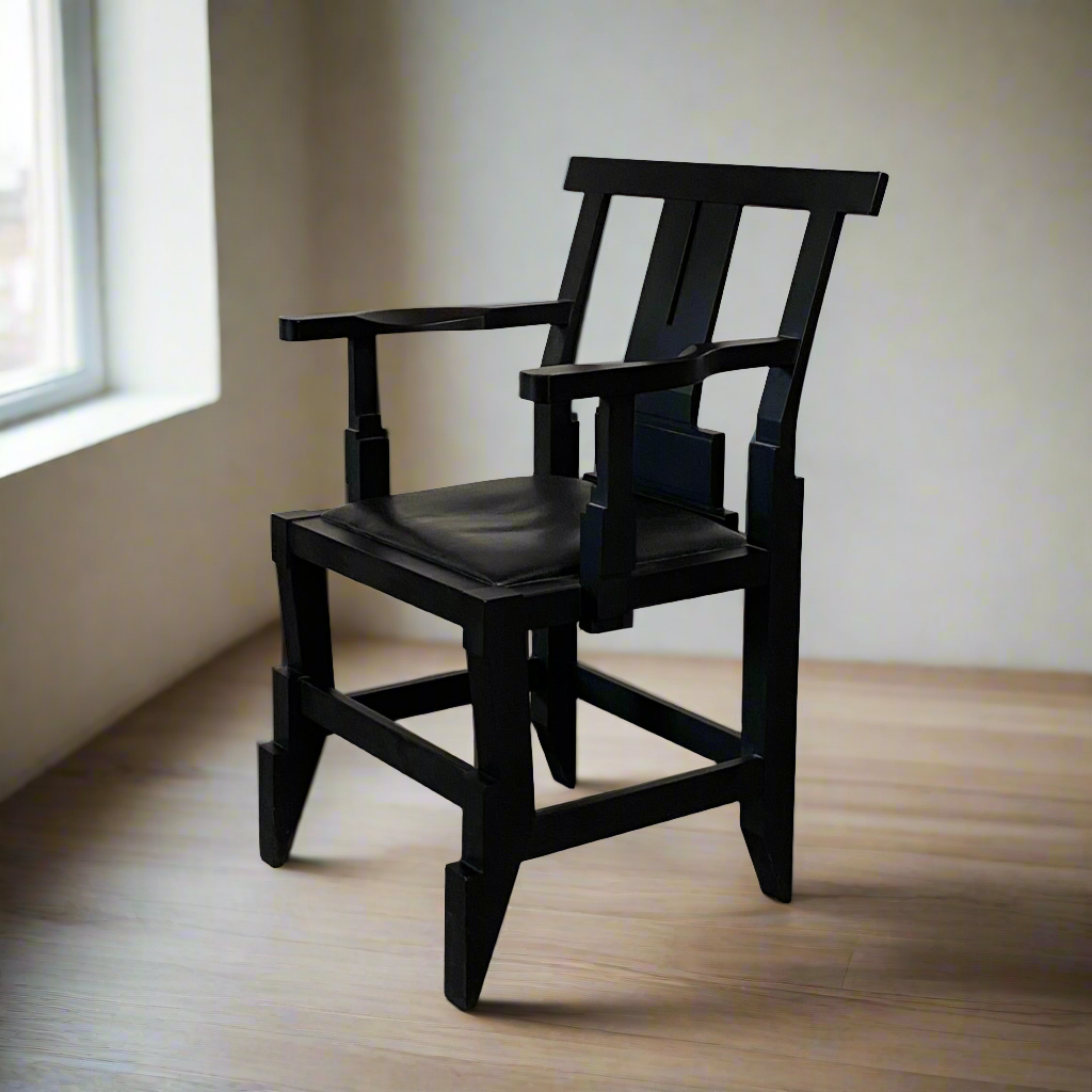 A rare vintage Solitar armchair by John Kandell, crafted in black wood, showcases an angular, geometric design that evokes the Memphis Design movement, displayed against a plain background.