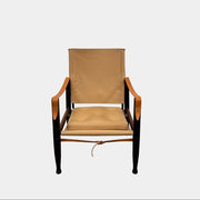 The Carl Hansen & Son KK47000 Safari Lounge Chair by Kaare Klint features canvas and leather with wooden legs and armrests, shown from the front on a plain white background.