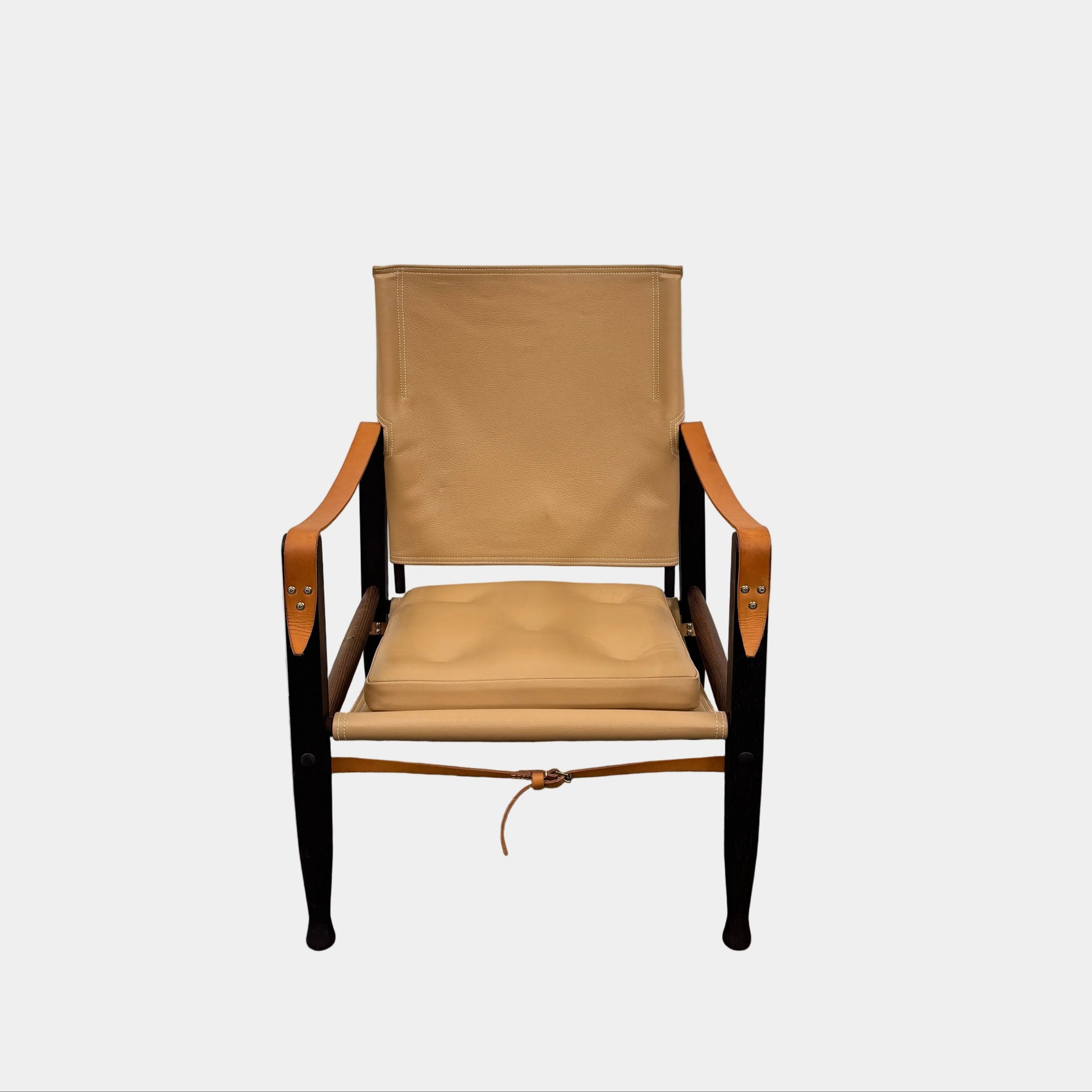 The Carl Hansen & Son KK47000 Safari Lounge Chair by Kaare Klint features canvas and leather with wooden legs and armrests, shown from the front on a plain white background.