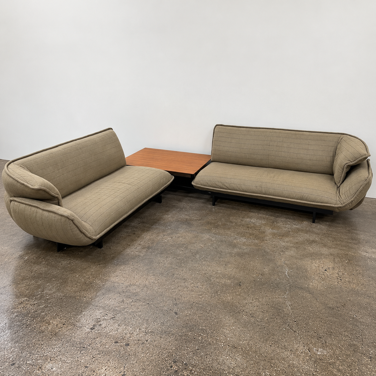 Two tan upholstered Cassina Beam Sectional Sofa with Corner Table sections connected by a rectangular wooden corner table.