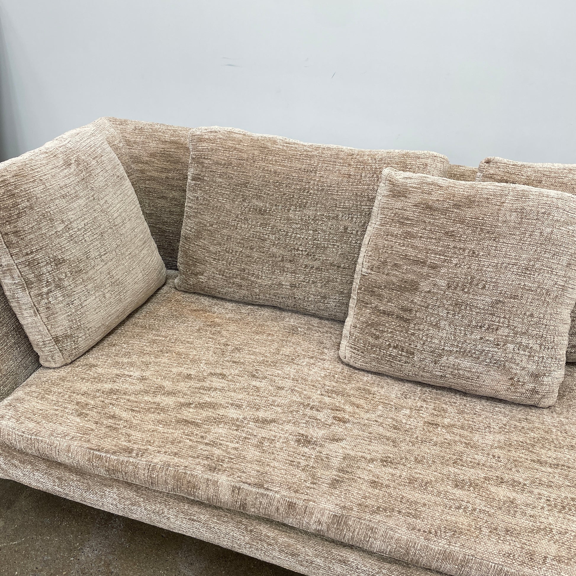 Introducing the B&B Italia Charles Sectional by Modern Resale: This beige L-shaped sectional sofa features textured fabric and stylish thin black metal legs. Set against a plain white background, it embodies modern elegance and timeless design.