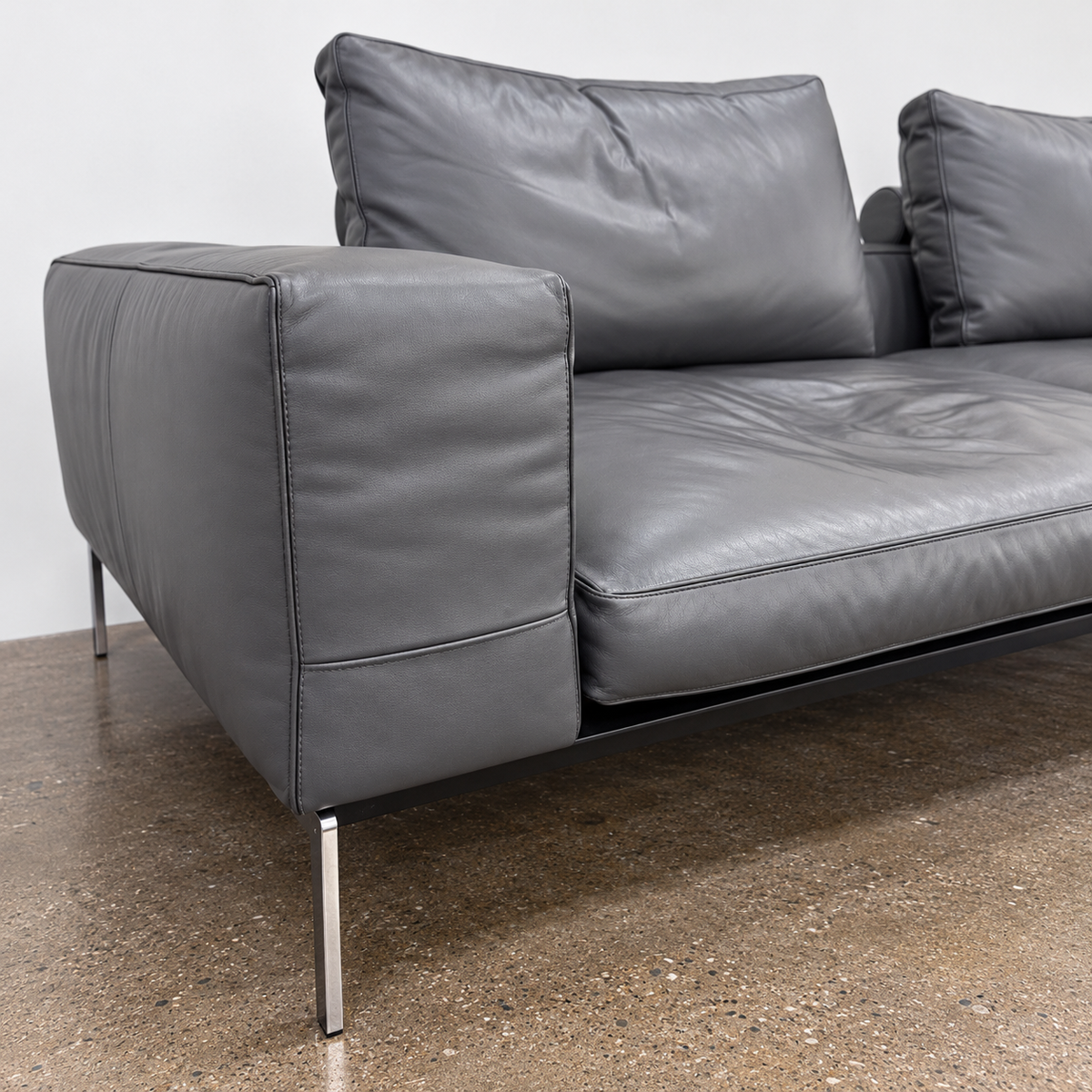 Flexform Lifesteel gray leather sofa on a thin metal frame with slender legs.
