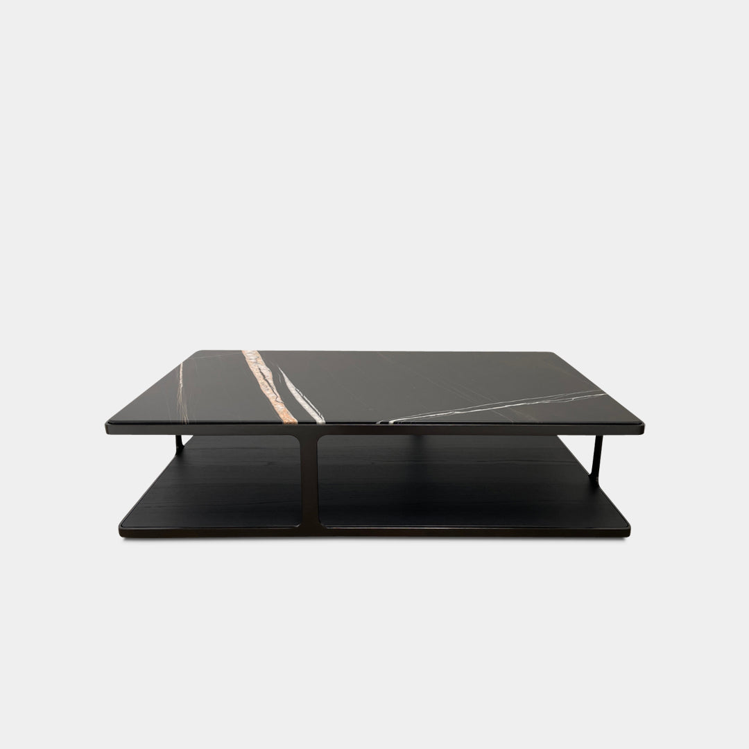 The Poliform Creek Marble Coffee Table is a rectangular Sahara Noir marble piece with a thin, horizontal design and subtle veining.