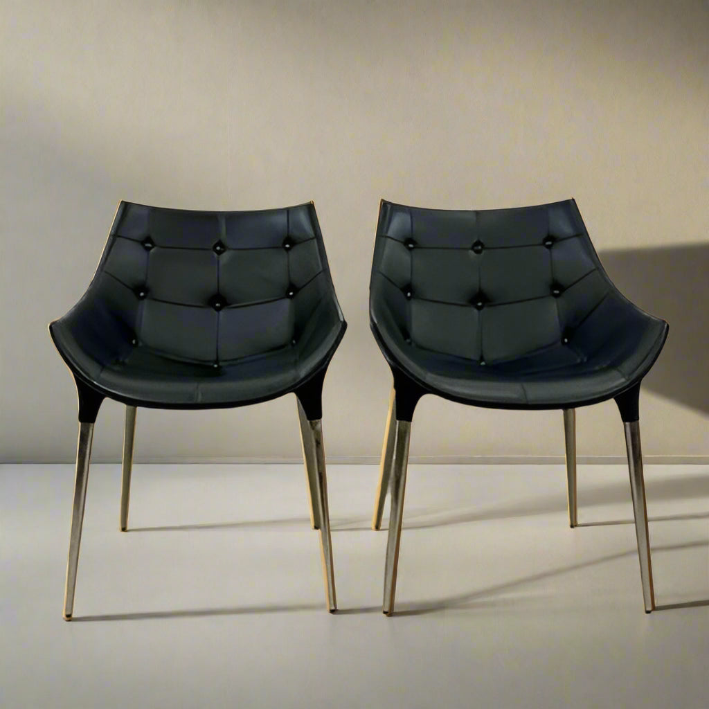 The Cassina Passion Side Chair by Cassina is a modern black upholstered chair with a curved backrest, button detailing, and four sleek metal legs inspired by the Passion design.