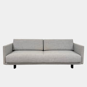 The DWR Tuck Sleeper Sofa by DWR features modern light gray fabric, straight arms, and black legs—ideal for a guest room. Shown against a plain white background.