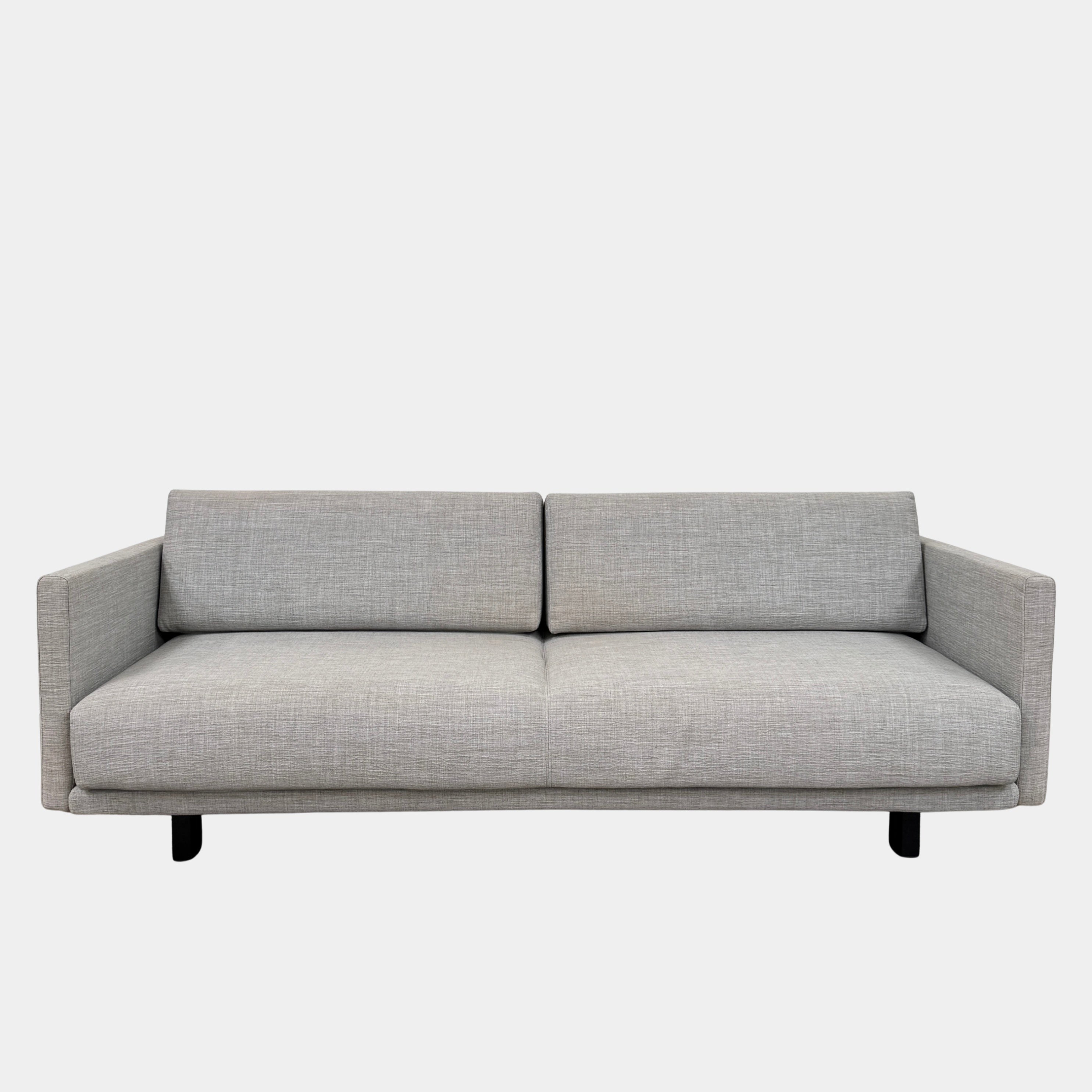 The DWR Tuck Sleeper Sofa by DWR features modern light gray fabric, straight arms, and black legs—ideal for a guest room. Shown against a plain white background.