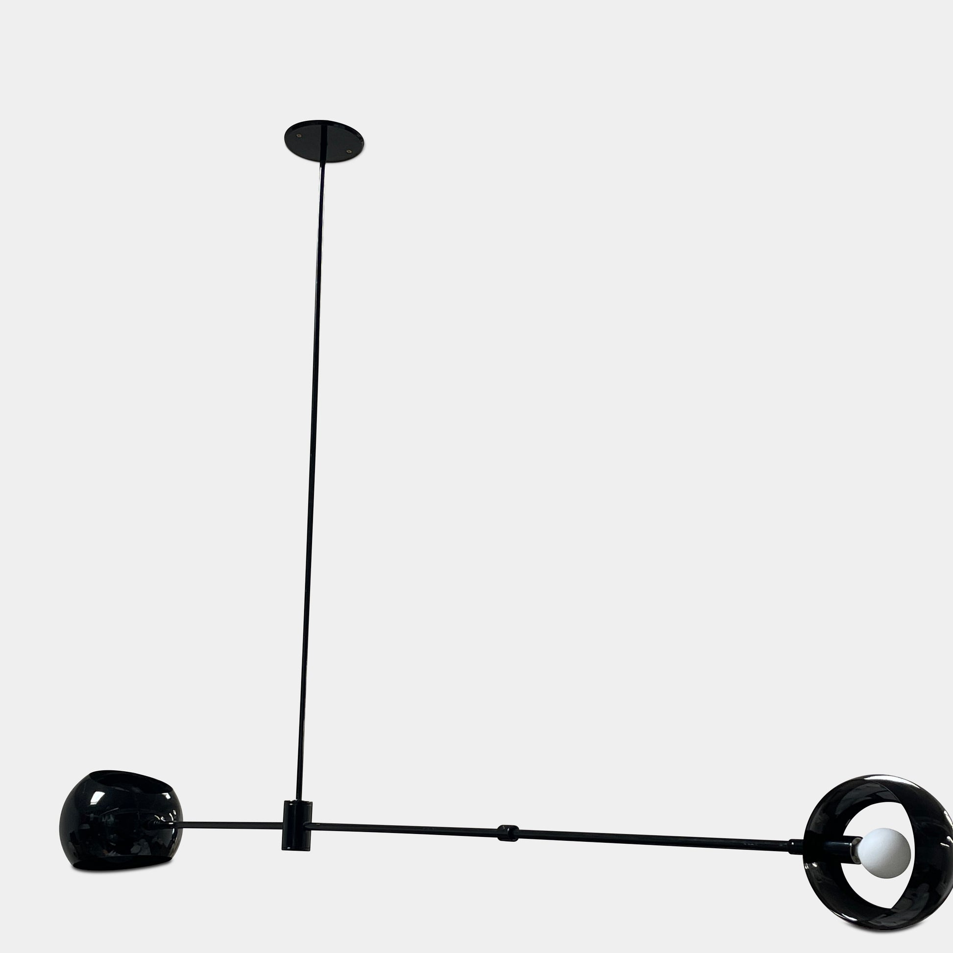 The David Weeks Studio Abaca Suspension Light is a custom-made, black, modern hanging fixture with two spherical bulbs. Crafted from powder-coated steel, it elegantly suspends from ceilings with exposed beams to add sophistication to any space.