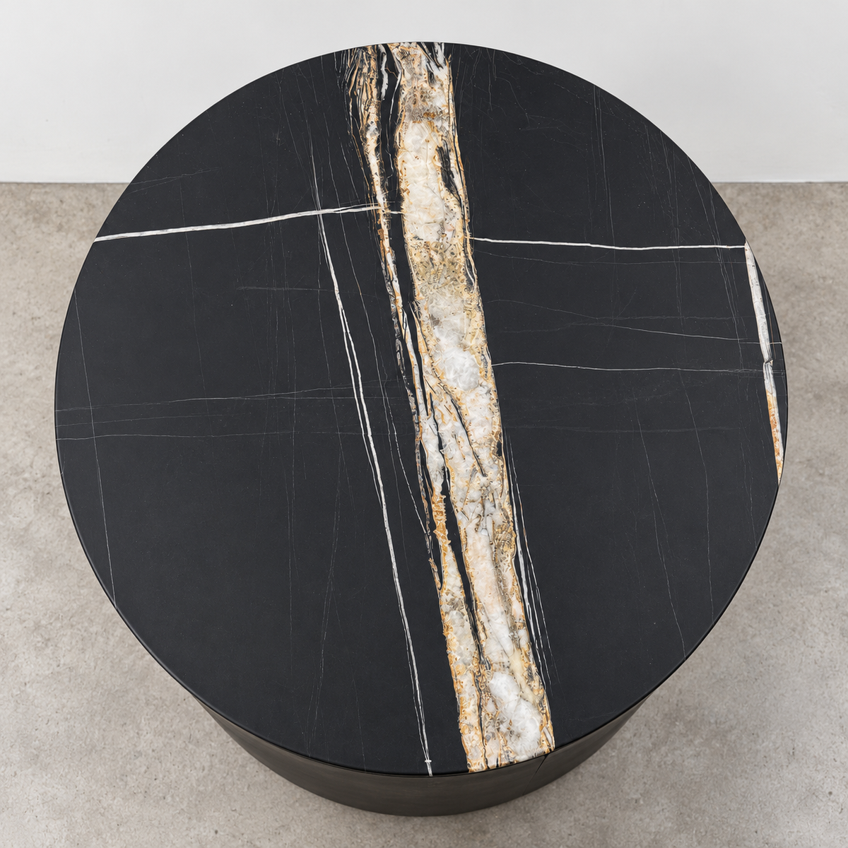 Two cylindrical Porada Tylsa 54 Nightstand Set of 2 units with dark marble tops featuring a single light-colored vein.