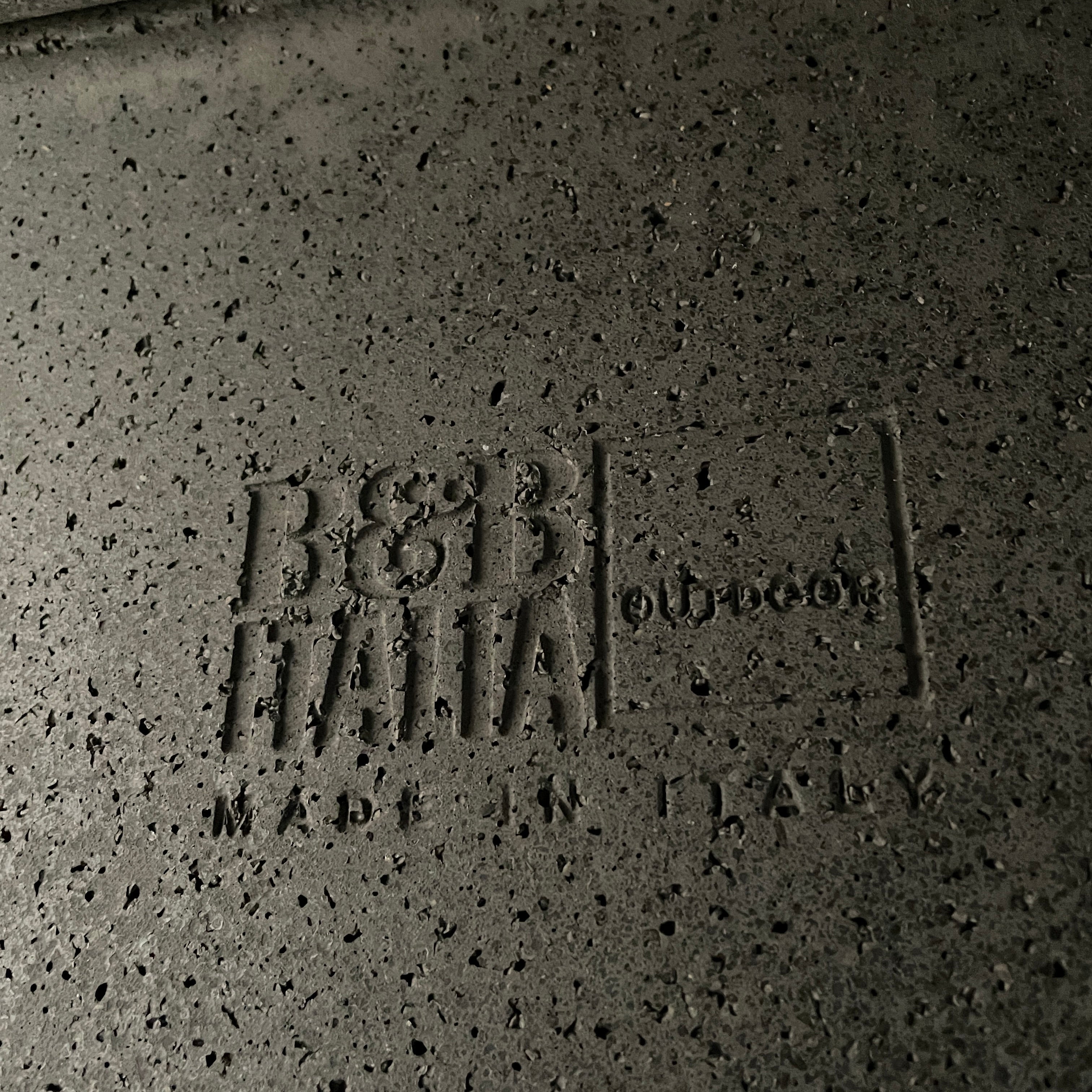 A rectangular black coffee table with asymmetrical supports on a white background, reminiscent of the B&B Italia Tobi-Ishi Outdoor Coffee Table (hold) by B&B Italia.