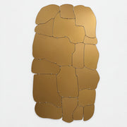 The Edra Miraggio Mirror by Edra features irregular, gold-toned metal panels with visible fasteners, mounted on a white background to highlight its artisanal craftsmanship.