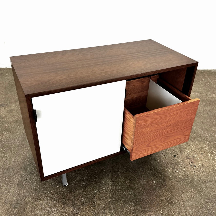 The Knoll Vintage Florence Knoll Office Storage features a dark wood frame, white sliding doors, and metal legs—perfect as a stylish credenza or office storage against a plain white wall.