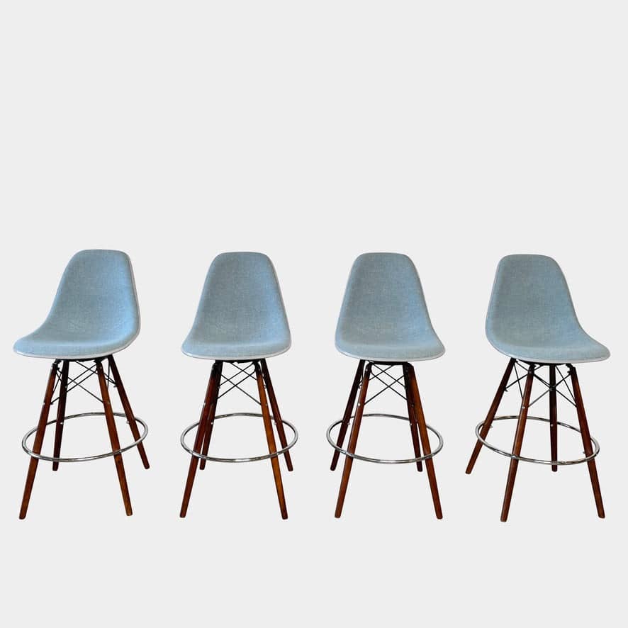 A set of four Modernica Case Study Bar Stool Set bar stools.