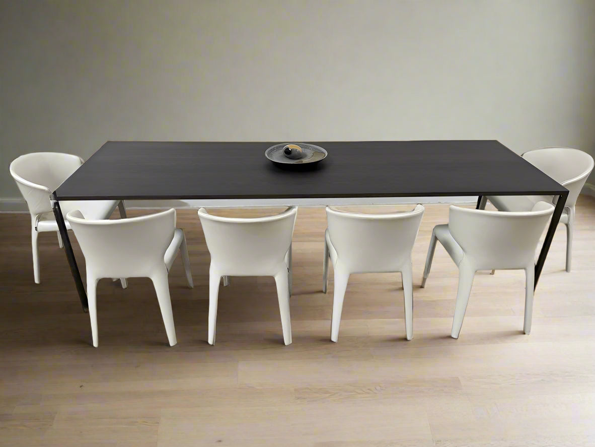 The Arco Slim Table by Arco is a minimalist rectangular table with a thin, flat surface and four slender legs, made from steel sandwich construction with a lightweight honeycomb core, shown against a plain white background.