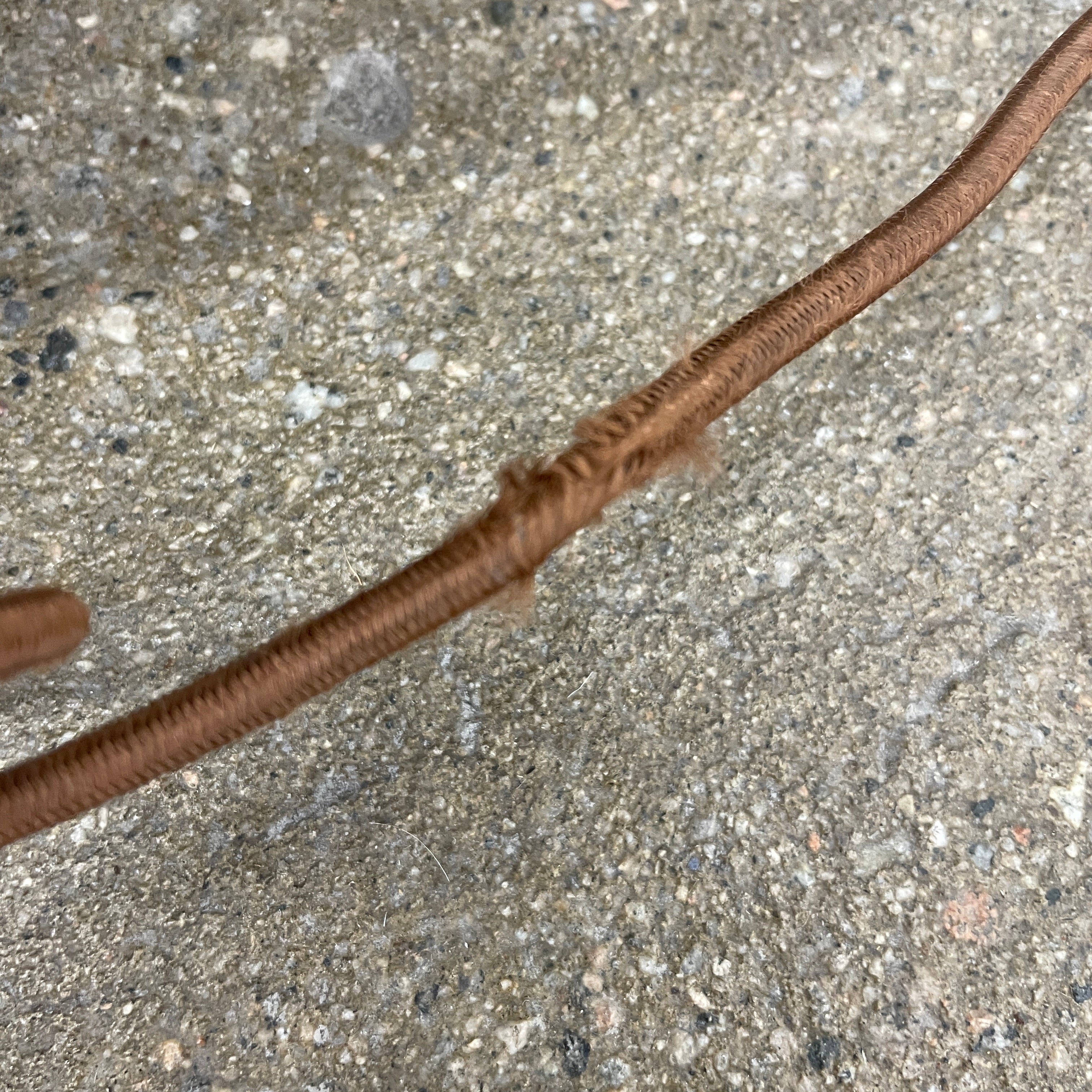 Introducing the Flos Metropolitan Table Light by Flos: a chic table lamp with a rectangular shade adorned with a diamond pattern, gracefully positioned on a square base.