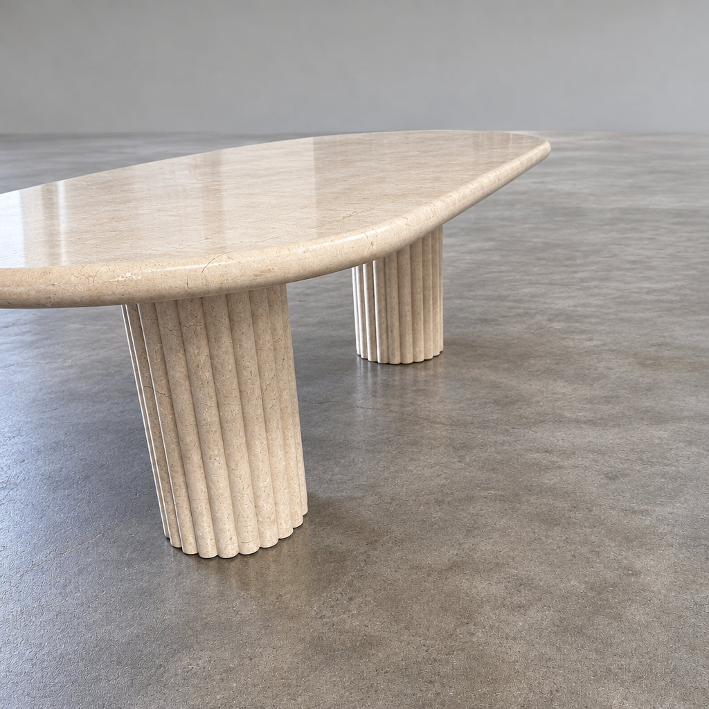 Form LA Fluta Oval Dining Table in Crema Marfil with a smooth top and two fluted cylindrical pedestals inspired by Roman architecture.
