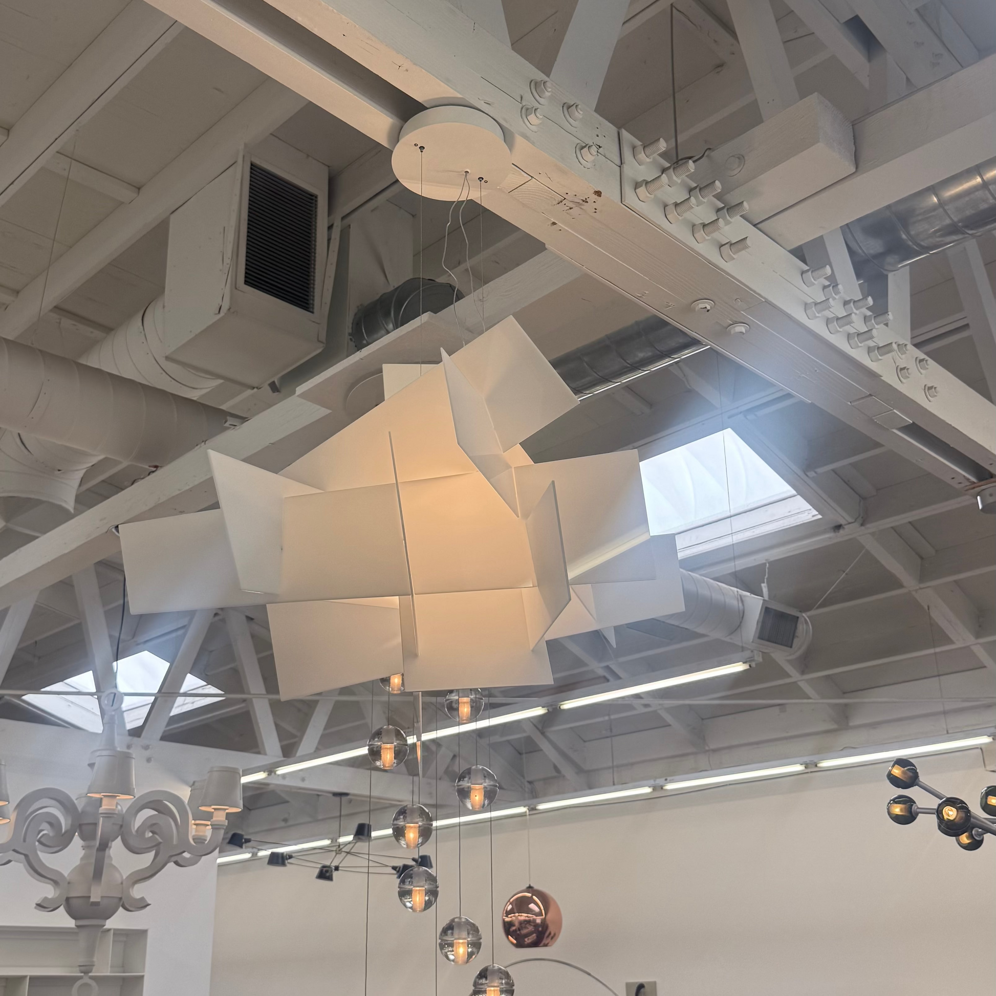 The Foscarini Big Bang LED Pendant, by Foscarini, features sculptural overlapping rectangular panels that emit a warm glow—ideal statement lighting for contemporary spaces.