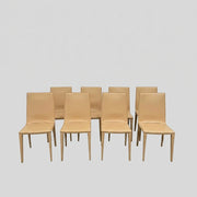 Eight light-tan Frag Bottega leather dining chairs arranged in two rows.